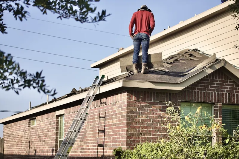Professional roofer working on a residential roof in Bullskin
